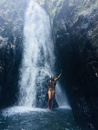 Girl in front of waterfall 