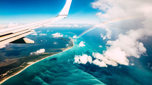 Aerial view of airplane wing over sea