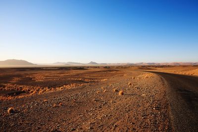 Scenic view of desert against clear sky