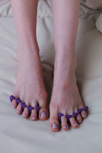 Close-up of female feet painted grey nail polish, self made pedicure at home.