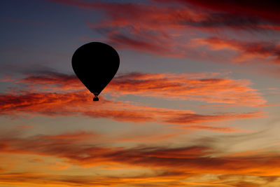 Low angle view of hot air balloon against orange sky