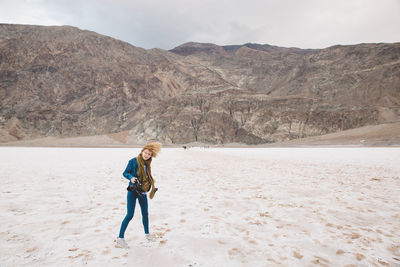 Woman standing on sand at death valley national park