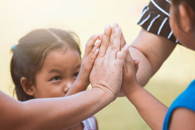 Girls with mothers joining hands