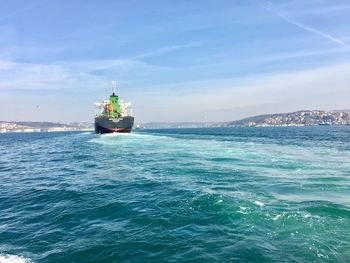 Ship sailing in sea against sky