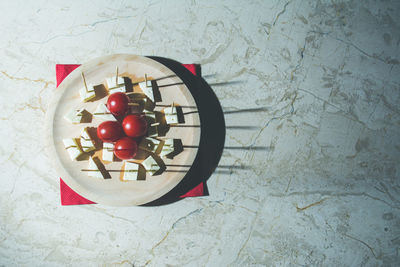 High angle view of cherries in bowl on table