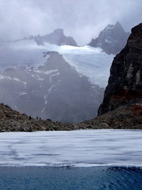 Scenic view of sea and mountains against sky