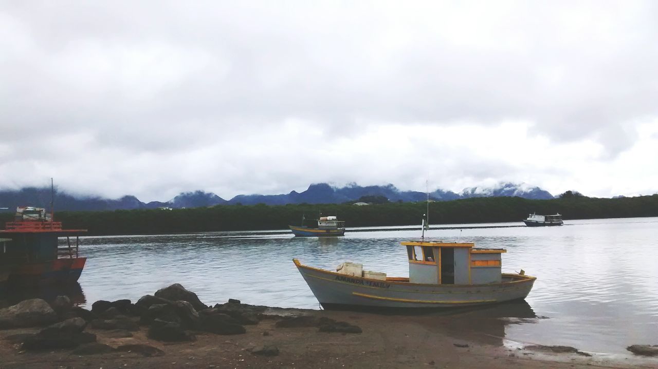 water, sky, cloud - sky, nautical vessel, mountain, cloudy, tranquility, tranquil scene, boat, lake, scenics, sea, pier, cloud, transportation, beauty in nature, nature, moored, mountain range, mode of transport