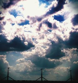 Low angle view of street light against cloudy sky