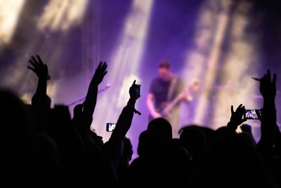 Group of silhouette people at music concert