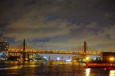 View of suspension bridge in city at night