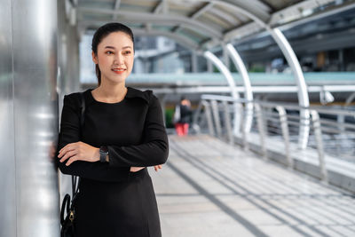 Portrait of a beautiful young woman standing in bus