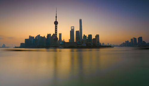 View of buildings in city during sunset