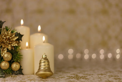 Close-up of christmas decorations with candles on table