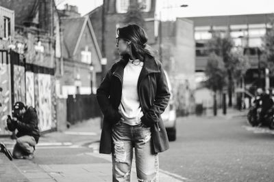 Full length of young woman standing on street