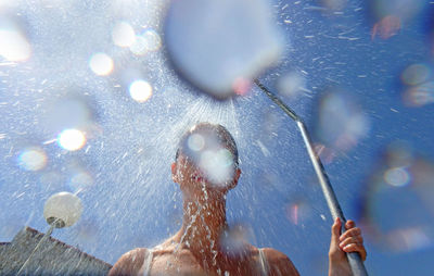 Low angle of woman showering outdoors