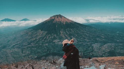 Rear view of man standing on mountain