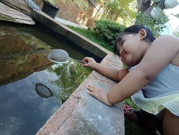 Low angle view of girl holding water