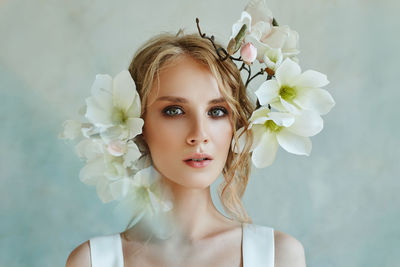 Close-up portrait of bride with flowers on head