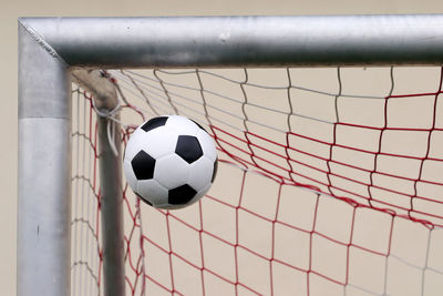 Close-up of soccer ball in goalpost