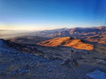 Scenic view of desert mountains against blue sky