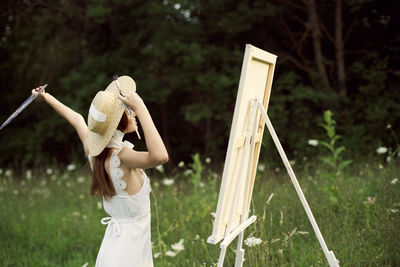 Midsection of woman holding umbrella while standing on land