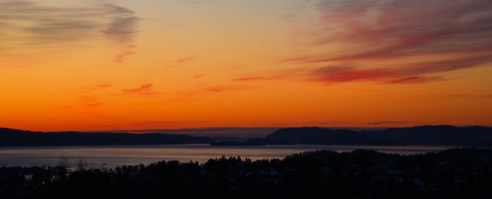 Scenic view of sea against romantic sky at sunset