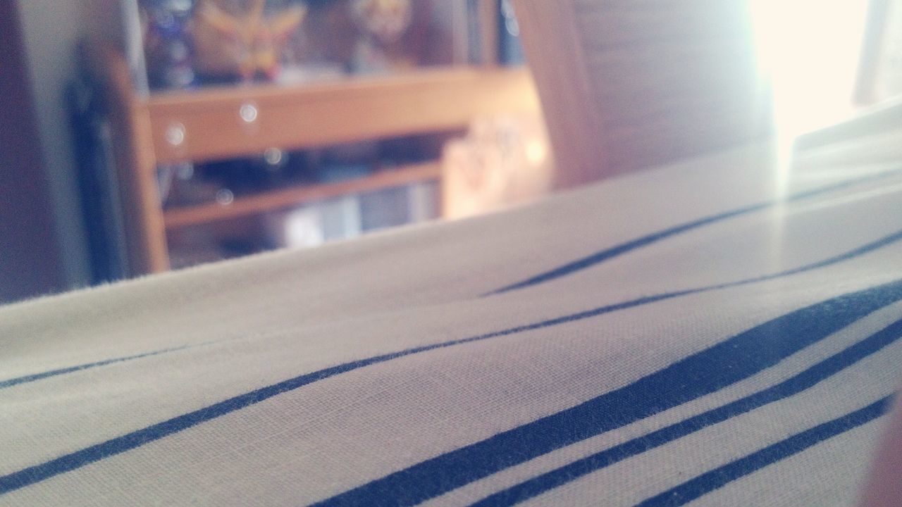 indoors, home interior, close-up, bed, sunlight, textile, no people, fabric, focus on foreground, pattern, curtain, absence, shadow, selective focus, domestic room, table, window, bedroom, wall - building feature, day