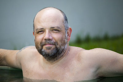 Portrait of shirtless man in swimming pool