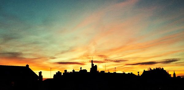 Silhouette of buildings against dramatic sky