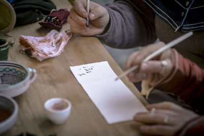 Midsection of woman preparing food on table