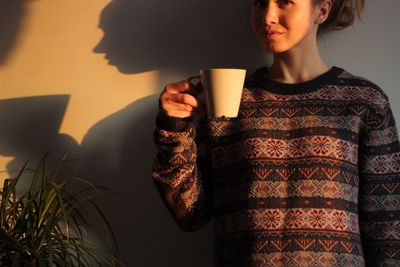 Woman holding coffee cup