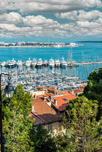 High angle view of harbor by city against sky