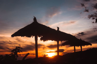 Silhouette built structure against sky during sunset