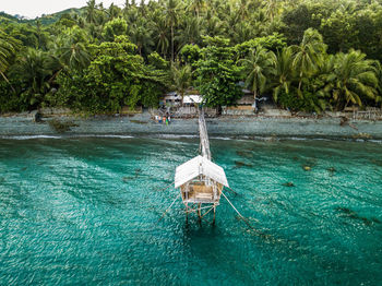 High angle view of stilt house at sea