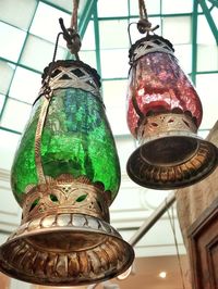 Low angle view of illuminated pendant lights hanging from ceiling