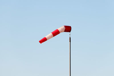 Low angle view of windsock against clear sky