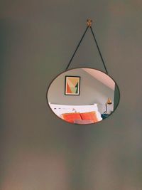 Close-up of electric lamp hanging against wall