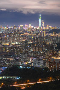 High angle view of illuminated cityscape against sky at night