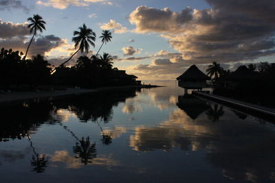 Scenic view of sea against cloudy sky at sunset