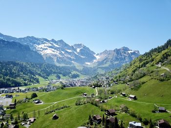 Scenic view of landscape and mountains against clear sky