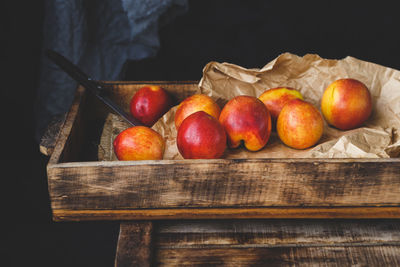 Close-up of apples on table against black background