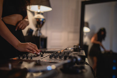 Fashionable young woman playing music at home