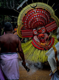 Rear view of man standing in traditional clothing