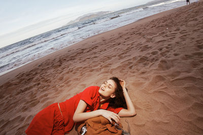 Young woman sitting at beach