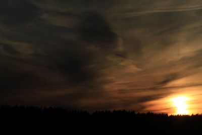 Scenic view of silhouette trees against sky at sunset