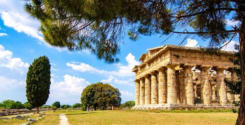 Low angle view of historical building against clear blue sky  , temple of paestum. italy