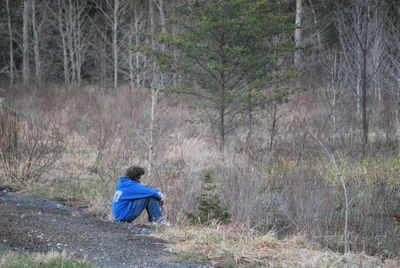 Man sitting at forest