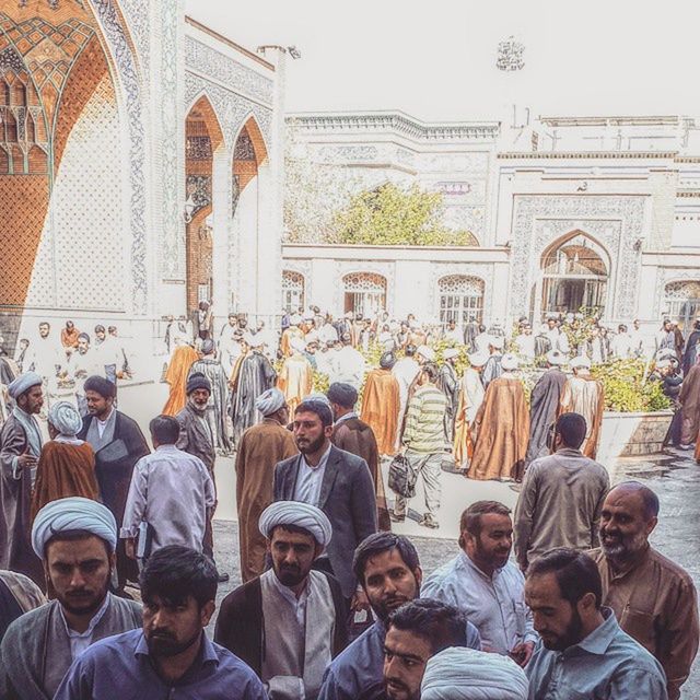 large group of people, architecture, men, built structure, lifestyles, person, building exterior, leisure activity, crowd, togetherness, mixed age range, religion, outdoors, day, sky, sitting, casual clothing, standing, tradition