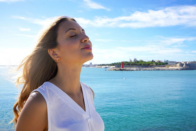 Close-up woman relaxing breathing fresh air on sea