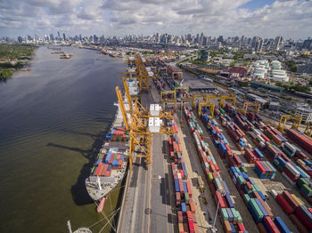 High angle view of commercial dock against sky in city